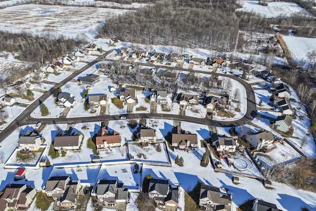 snowy aerial view with a residential view