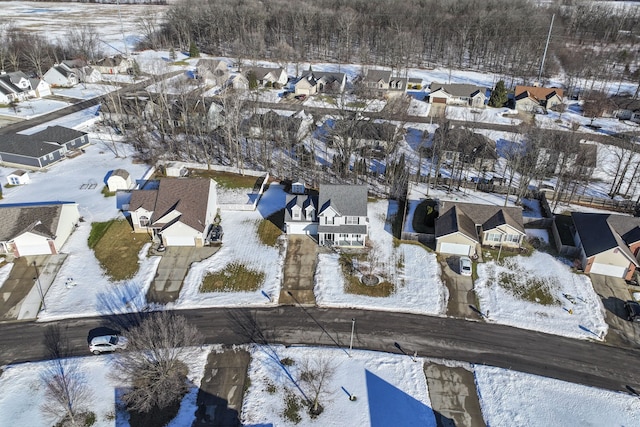 snowy aerial view with a residential view