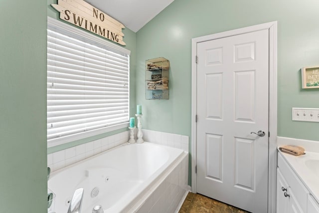 bathroom featuring a jetted tub and vanity