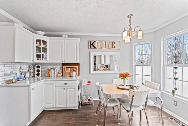 kitchen with dark wood finished floors, visible vents, backsplash, glass insert cabinets, and white cabinets