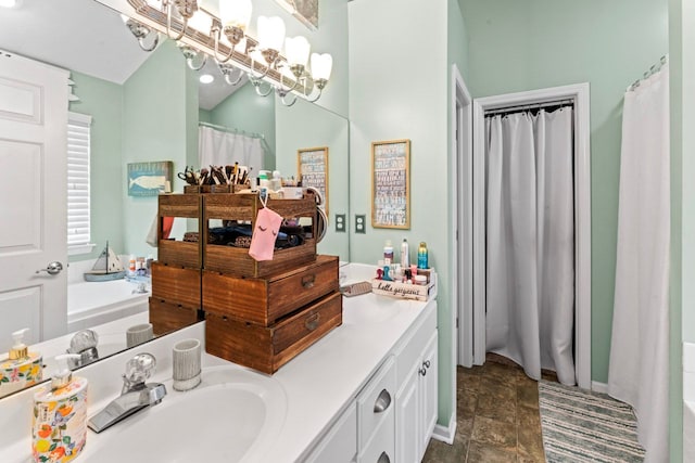 full bathroom featuring double vanity, a sink, and a washtub