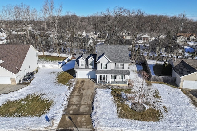 snowy aerial view featuring a residential view