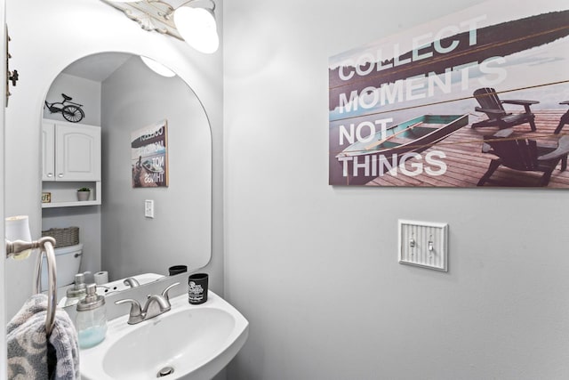 half bath featuring a sink and toilet