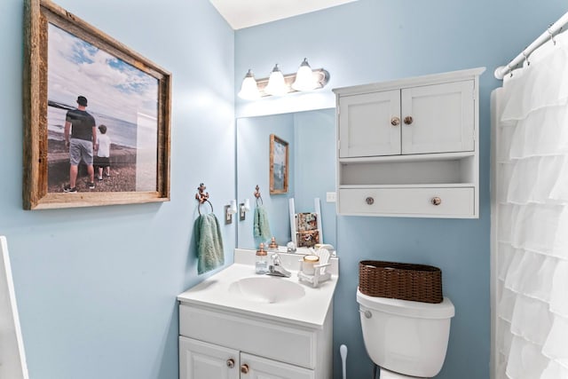 bathroom featuring toilet and vanity