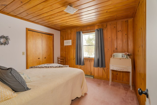 7214 S M 66, Mancelona, MI 49659 - bedroom with wood walls, light colored carpet, a baseboard heating unit, wood ceiling, and a closet
