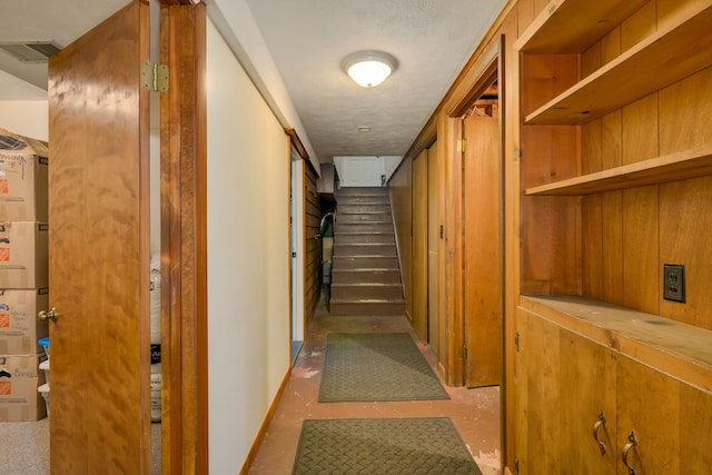 7214 S M 66, Mancelona, MI 49659 - hall with baseboards, visible vents, and stairway