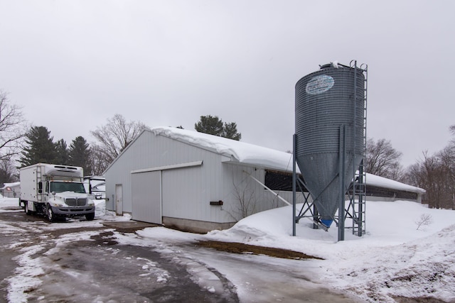 7214 S M 66, Mancelona, MI 49659 - snow covered structure with an outbuilding and a pole building