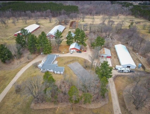 birds eye view of property with a rural view