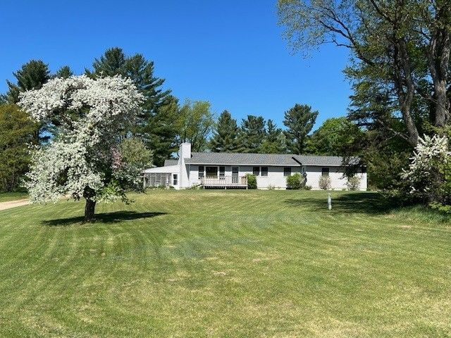 7214 S M 66, Mancelona, MI 49659 - exterior space with a front lawn and a wooden deck