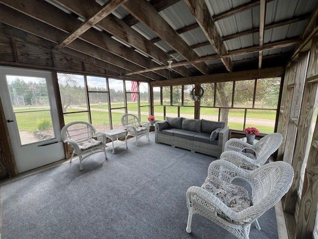 7214 S M 66, Mancelona, MI 49659 - unfurnished sunroom featuring an outdoor living space