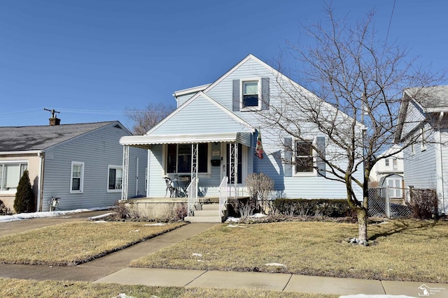 view of front of house with a front yard and covered porch