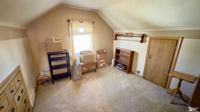 additional living space with lofted ceiling, light carpet, and visible vents