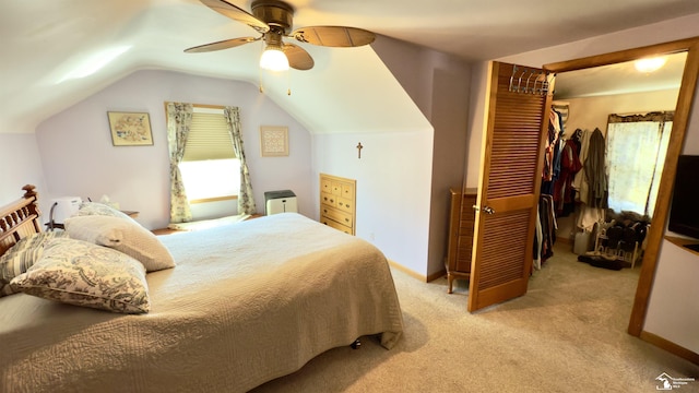 bedroom with light carpet, baseboards, vaulted ceiling, and a closet