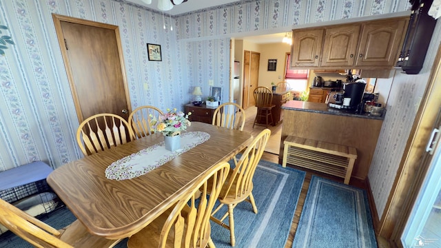 dining area with visible vents and wallpapered walls