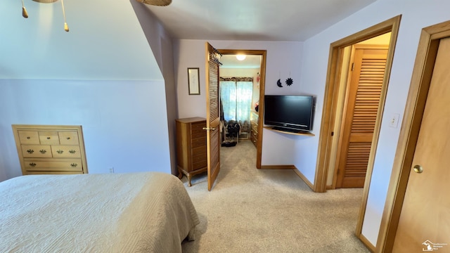 bedroom featuring light colored carpet and baseboards