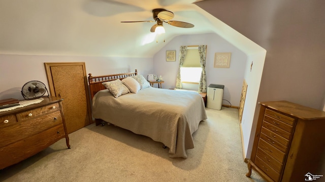 bedroom with lofted ceiling, a ceiling fan, and light colored carpet