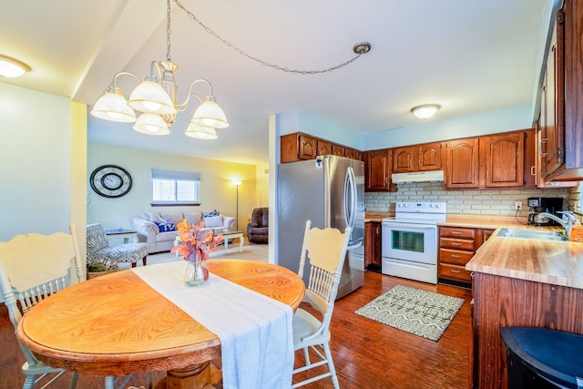 kitchen with white range with electric stovetop, light countertops, freestanding refrigerator, a sink, and under cabinet range hood