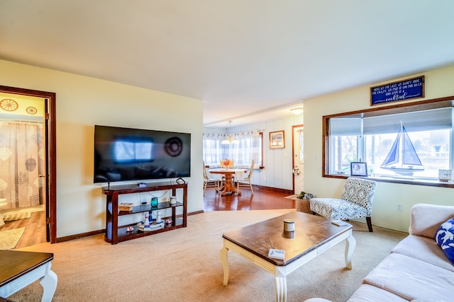 carpeted living room featuring baseboards