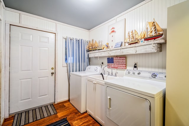 washroom featuring dark wood-type flooring, laundry area, and separate washer and dryer