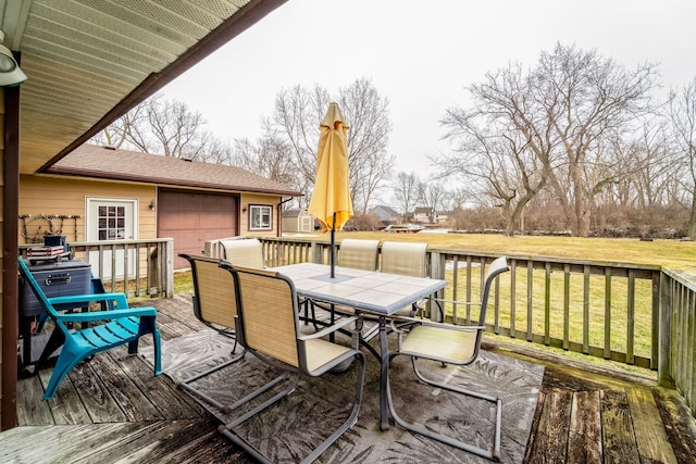 wooden terrace featuring outdoor dining area and a yard