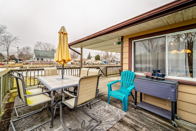 wooden deck featuring outdoor dining space