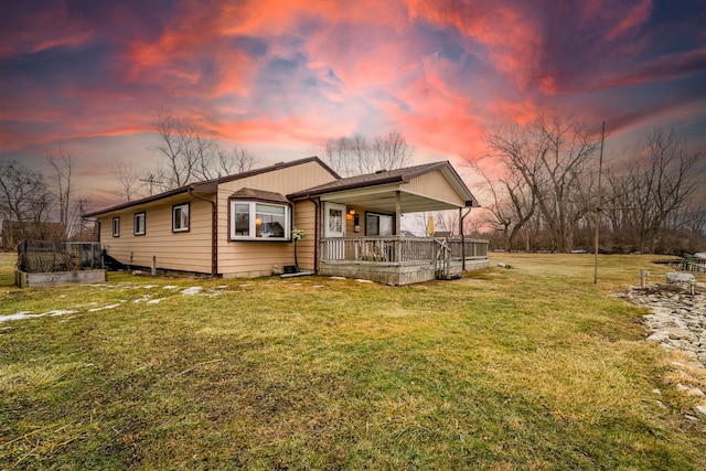 view of front facade featuring covered porch and a yard