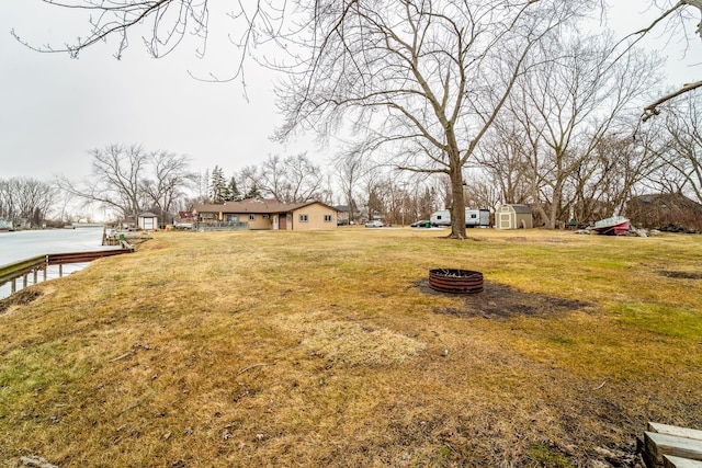 view of yard with a fire pit