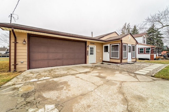 single story home featuring a garage and concrete driveway