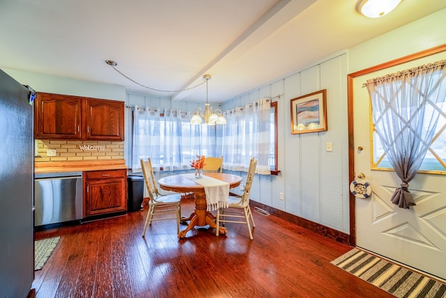 dining area featuring dark wood-style floors, a chandelier, and baseboards