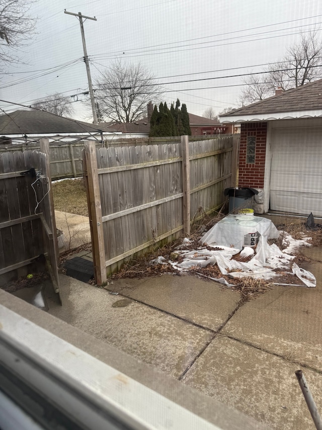 view of yard with a garage and fence