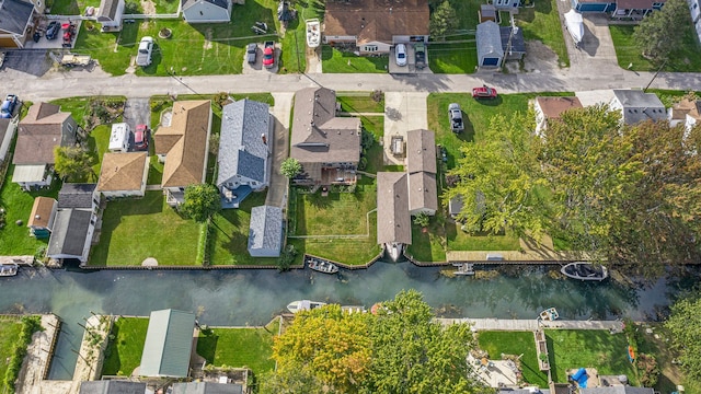 birds eye view of property with a water view and a residential view