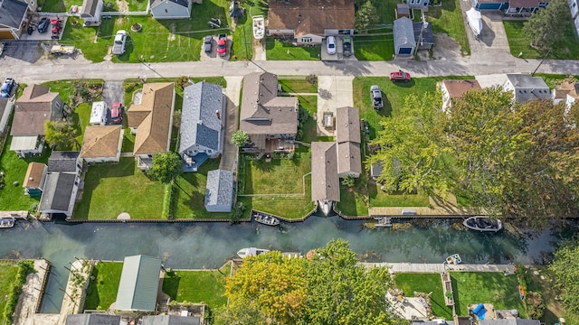 drone / aerial view with a residential view and a water view