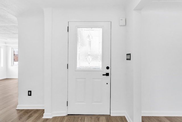 entrance foyer with wood finished floors and baseboards