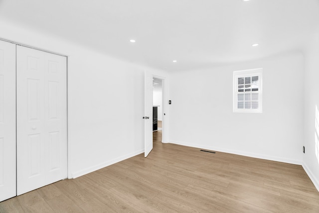 unfurnished bedroom featuring recessed lighting, baseboards, visible vents, and light wood finished floors