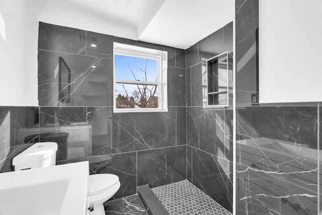 full bathroom with a walk in shower, marble finish floor, toilet, and tile walls