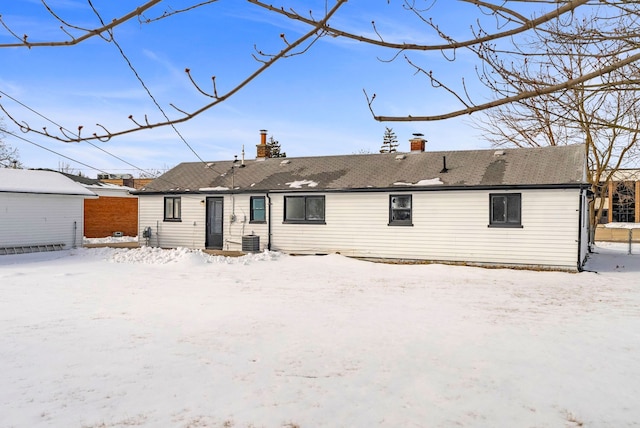 snow covered property featuring a chimney