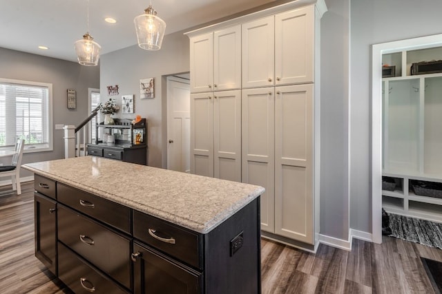 kitchen with a kitchen island, recessed lighting, dark wood-style flooring, hanging light fixtures, and white cabinets