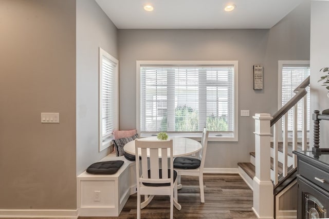 dining room featuring recessed lighting, baseboards, dark wood-type flooring, and stairs