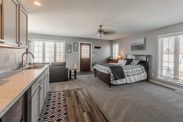 bedroom with multiple windows, baseboards, and a sink