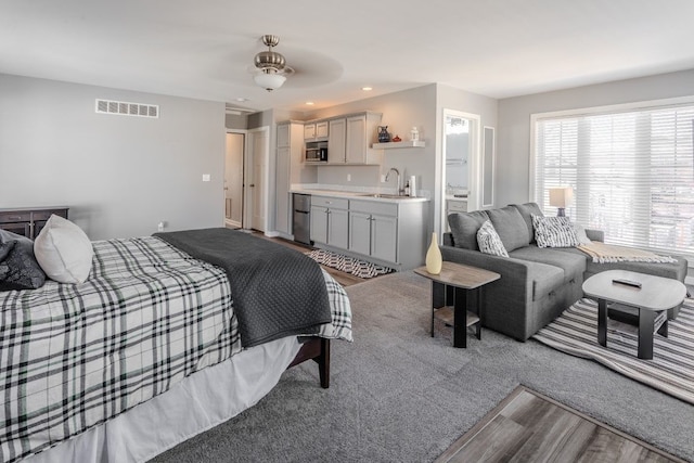 bedroom with ensuite bath, recessed lighting, visible vents, and a sink