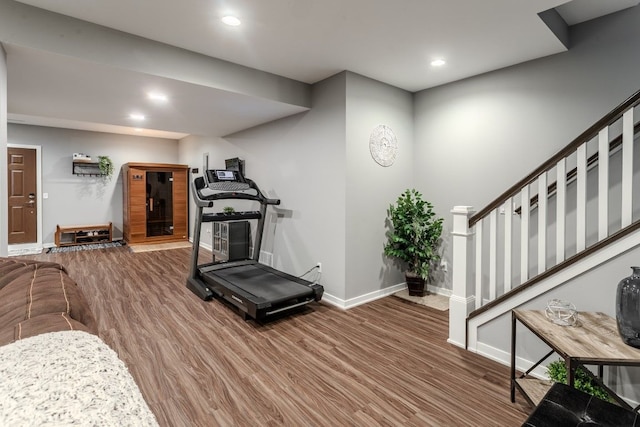 exercise room with recessed lighting, wood finished floors, and baseboards