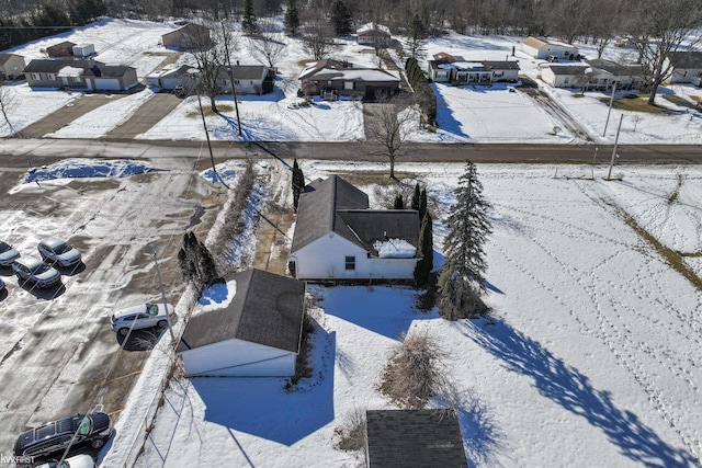 snowy aerial view with a residential view