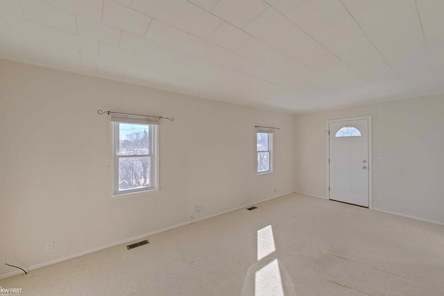 interior space featuring a healthy amount of sunlight, visible vents, and baseboards