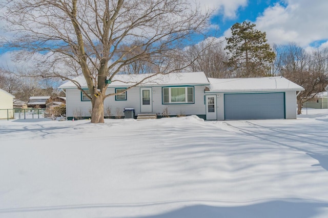 single story home with an attached garage and fence