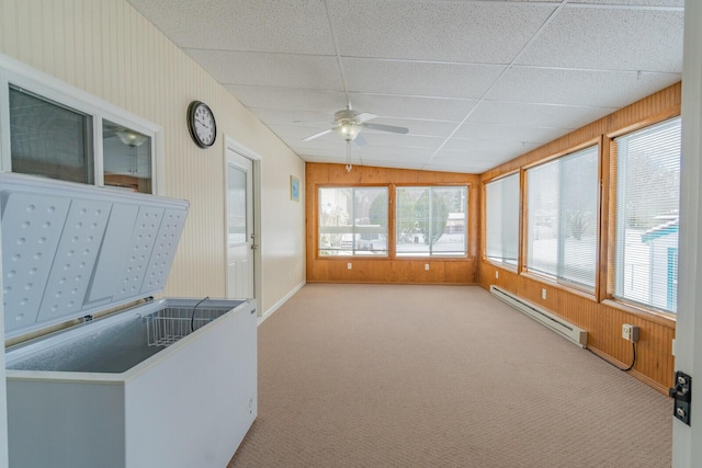 sunroom / solarium with a paneled ceiling, ceiling fan, and a baseboard heating unit