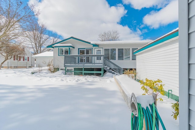 snow covered property featuring a deck