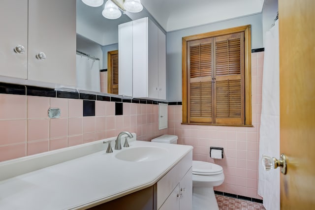 full bathroom featuring tile patterned flooring, tile walls, toilet, and vanity