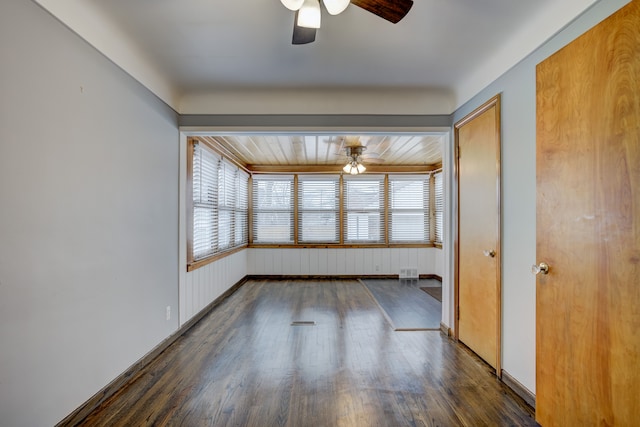 spare room featuring ceiling fan, visible vents, hardwood / wood-style flooring, and a wealth of natural light