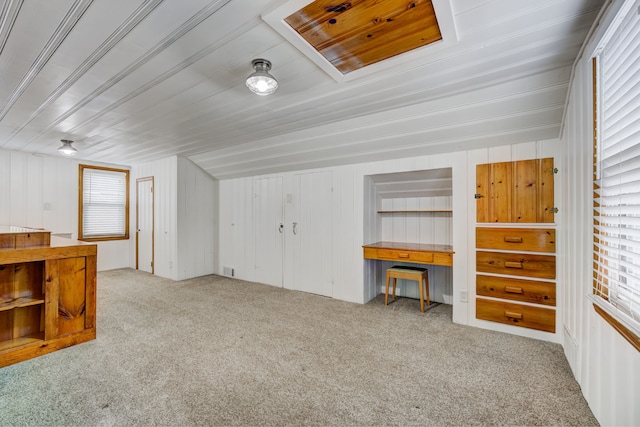 bonus room featuring carpet and built in desk