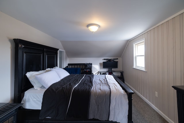 bedroom featuring vaulted ceiling, baseboards, and carpet floors